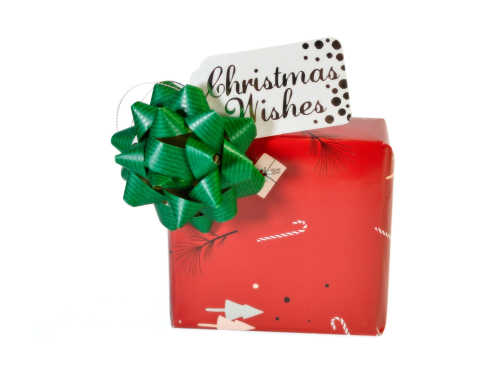 Punainen lahjapaketti jossa rusetti ja kortti jossa lukee "Christmas wishes"